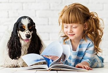 girl and dog reading