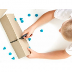photo of kid cutting cardboard